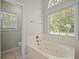 Bright main bathroom features a soaking tub, large window, and a separate toilet area at 121 Arrowridge Ct, Summerville, SC 29485