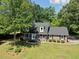 An aerial view of the property showcasing a two-story home, mature trees, and a spacious lawn at 122 Mellard Dr, Goose Creek, SC 29445