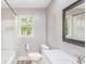 Bright bathroom with tub, shower, and a large mirror at 122 Mellard Dr, Goose Creek, SC 29445