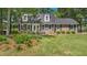 Charming two-story brick home with a well-manicured lawn, black shutters, and dormer windows at 122 Mellard Dr, Goose Creek, SC 29445