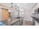An island kitchen featuring stainless appliances, stone countertops, pendant lights, and views to the fireplace at 122 Mellard Dr, Goose Creek, SC 29445