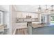 Bright kitchen with light gray cabinets, modern stainless appliances, mosaic tile backsplash, and gray island at 122 Mellard Dr, Goose Creek, SC 29445