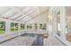 Inviting sunroom with vaulted ceilings, exposed beams, brick accents, and lots of windows at 122 Mellard Dr, Goose Creek, SC 29445