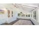 Bright sunroom featuring brick walls, a ceiling fan, and a colorful rug on dark wood floors at 122 Mellard Dr, Goose Creek, SC 29445