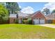 Charming single-story brick home featuring solar panels, a two-car garage, and well-maintained landscaping at 1287 Chatfield St, Mount Pleasant, SC 29464