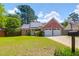 Charming single-story brick home featuring solar panels, a two-car garage, and well-maintained landscaping at 1287 Chatfield St, Mount Pleasant, SC 29464