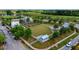 A unique community with a green common area, surrounded by houses and community buildings at 130 Spotted Way, Summerville, SC 29485
