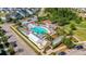 An aerial view showcases the community pool with colorful umbrellas, surrounded by lush landscaping at 130 Spotted Way, Summerville, SC 29485