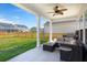 Back porch with outdoor seating, ceiling fan, and view of the backyard at 130 Spotted Way, Summerville, SC 29485