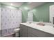 Bathroom featuring green walls, a shower and tub, and a gray vanity at 130 Spotted Way, Summerville, SC 29485