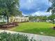 Inviting community green space surrounded by colorful homes and lush landscaping under a cloudy sky at 130 Spotted Way, Summerville, SC 29485