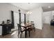 Dining area with dark wood table, bench seating, and a modern chandelier at 130 Spotted Way, Summerville, SC 29485