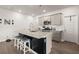 Kitchen with granite counters, stainless microwave, oven, and a black island with stools at 130 Spotted Way, Summerville, SC 29485