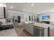 Open kitchen with stainless appliances, granite counters, island, and view to living room at 130 Spotted Way, Summerville, SC 29485