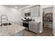 Kitchen with stainless microwave, range, tile backsplash, and view to pantry at 130 Spotted Way, Summerville, SC 29485