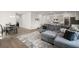 Open living space with hardwood flooring, a sectional sofa, and a view of the kitchen and dining area at 130 Spotted Way, Summerville, SC 29485