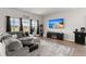 Cozy living room with a large sectional sofa, fireplace, and entertainment center at 130 Spotted Way, Summerville, SC 29485