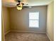 Bedroom with ceiling fan and a window, featuring neutral paint and carpeting at 1333 Song Sparrow Way, Hanahan, SC 29410