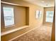 Neutral bedroom features natural light from three windows with blinds and neutral carpeting at 1333 Song Sparrow Way, Hanahan, SC 29410