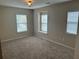 Neutral bedroom features natural light from three windows with blinds and neutral carpeting at 1333 Song Sparrow Way, Hanahan, SC 29410