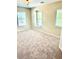 Bedroom featuring neutral carpet, trim, and walls, and natural light from three windows at 1333 Song Sparrow Way, Hanahan, SC 29410