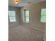 Neutral bedroom features natural light from two large windows with blinds and neutral carpeting at 1333 Song Sparrow Way, Hanahan, SC 29410