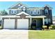 Beautiful two-story home featuring a two-car garage, brick accents, and a well-manicured lawn at 1333 Song Sparrow Way, Hanahan, SC 29410