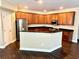 Modern kitchen with stainless steel appliances, dark granite countertops, wood cabinets and an island at 1333 Song Sparrow Way, Hanahan, SC 29410
