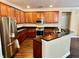 Modern kitchen with stainless steel appliances, dark granite countertops and wood cabinets at 1333 Song Sparrow Way, Hanahan, SC 29410