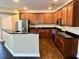 Modern kitchen with stainless steel appliances, dark granite countertops, wood cabinets and a breakfast bar at 1333 Song Sparrow Way, Hanahan, SC 29410