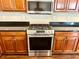 Close-up of a stainless steel oven and cooktop below a stainless steel microwave at 1333 Song Sparrow Way, Hanahan, SC 29410
