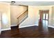 Bright living room featuring hardwood floors and staircase with wooden handrail at 1333 Song Sparrow Way, Hanahan, SC 29410