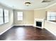 Open living room featuring hardwood floors, white trim, a fireplace and windows with wooden blinds at 1333 Song Sparrow Way, Hanahan, SC 29410