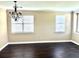 Spacious living room featuring hardwood floors, white trim and two windows with wooden blinds at 1333 Song Sparrow Way, Hanahan, SC 29410