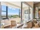 Inviting balcony space with chairs, table, and stunning cityscape view with open sliding glass door at 14 Lockwood Dr # 4C, Charleston, SC 29401