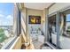 Attractive balcony space with chair, table, and marina view with open sliding glass door at 14 Lockwood Dr # 4C, Charleston, SC 29401
