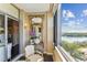 Inviting balcony space with chair, decor, and stunning waterfront view with open sliding glass door at 14 Lockwood Dr # 4C, Charleston, SC 29401