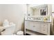 Bright bathroom features a granite countertop, decorative mirror and white cabinets for plenty of storage at 14 Lockwood Dr # 4C, Charleston, SC 29401
