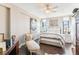 Bedroom with a ceiling fan features stylish decor, a lounger and two bright windows at 14 Lockwood Dr # 4C, Charleston, SC 29401