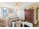 Bedroom with ceiling fan features windows with views and a unique wooden armoire at 14 Lockwood Dr # 4C, Charleston, SC 29401