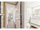 Hallway to a bathroom featuring hardwood floors and neutral walls at 14 Lockwood Dr # 4C, Charleston, SC 29401