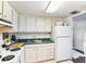 Clean, organized kitchen features bright white cabinets and appliances for cooking enjoyment at 14 Lockwood Dr # 4C, Charleston, SC 29401