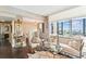 Bright living room features stylish seating, glass tables, and stunning views of the water at 14 Lockwood Dr # 4C, Charleston, SC 29401