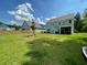 Spacious backyard featuring lush lawn, wooden fence, and a screened-in porch, perfect for outdoor enjoyment at 141 Cherry Grove Dr, Summerville, SC 29483