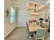 Elegant dining room featuring coffered ceilings, a modern chandelier, and a beautiful wood dining table at 141 Cherry Grove Dr, Summerville, SC 29483