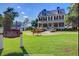 Beautiful farmhouse with manicured lawn and landscaping, showcasing a social center for community gatherings at 141 Cherry Grove Dr, Summerville, SC 29483
