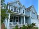 Charming two-story home showcasing a welcoming front porch and well-maintained landscaping, exuding curb appeal at 141 Cherry Grove Dr, Summerville, SC 29483