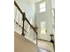 Bright foyer boasting a high ceiling, staircase with wood railing, and a stylish rug, creating a grand entrance at 141 Cherry Grove Dr, Summerville, SC 29483