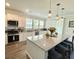 Modern kitchen with white cabinetry, granite countertops, stainless steel appliances, and a large island with seating at 141 Cherry Grove Dr, Summerville, SC 29483