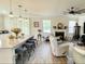 Open-concept living area featuring a granite island with seating, fireplace, and natural light from large windows at 141 Cherry Grove Dr, Summerville, SC 29483